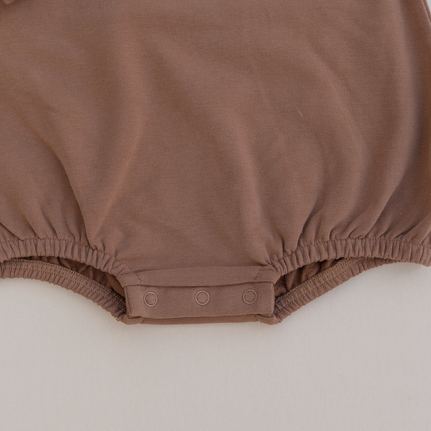 Brown baby romper on a light gray background