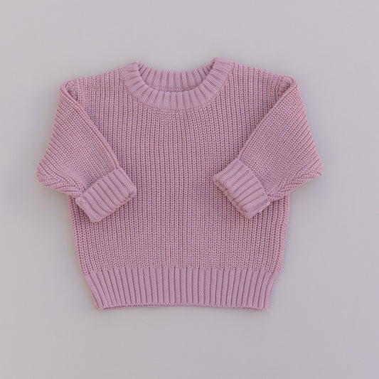 A pink organic cotton knit sweater for babies, displayed against a white background.
