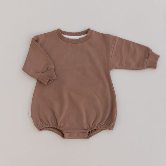 Organic cotton rompers for babies, in solid brown with long sleeves and snaps at the bottom.