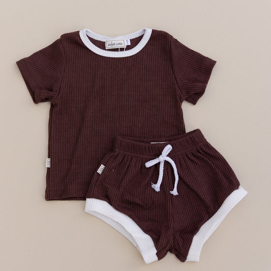 A set of children's clothing, consisting of a brown ribbed t-shirt and matching shorts with white contrast trim and a drawstring.
