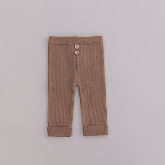A pair of brown organic cotton leggings with buttons at the waist, laid flat on a white background.